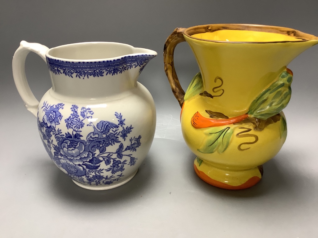 A Burleigh 'Earth laughs' jug, a majolica jug, a Wade heath jug, a Handleys jug and a salt cellar